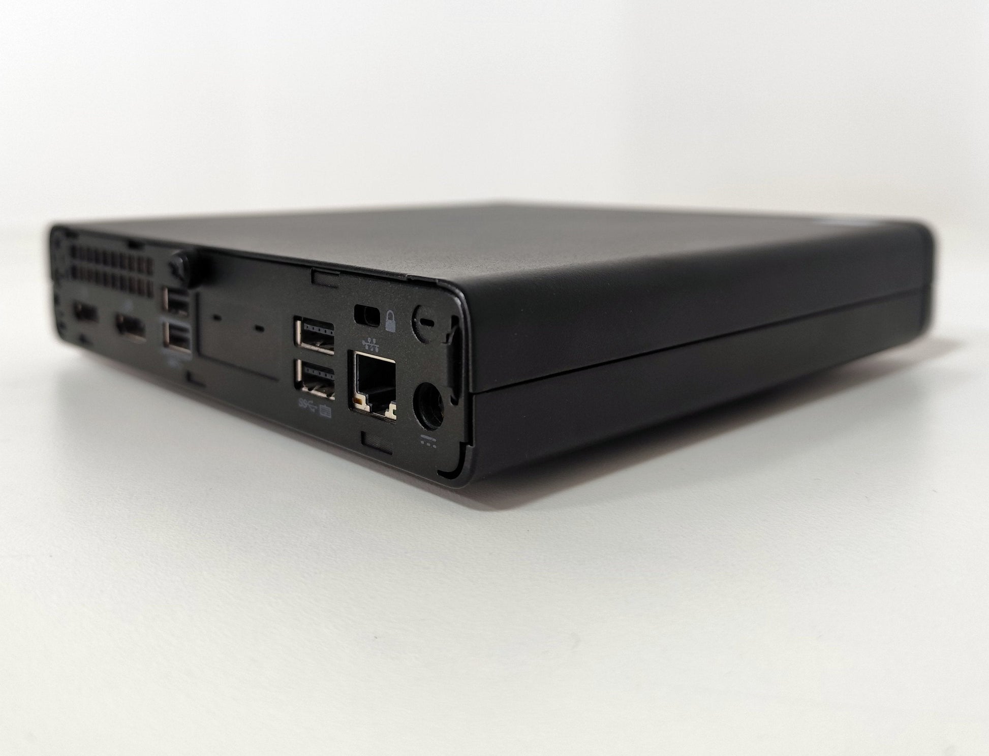 Refurbished compact mini PC with USB ports and Ethernet, on white background at Messoanuovo.it