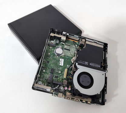 Open mini PC showing internal motherboard and cooling fan on white background, Messoanuovo.it